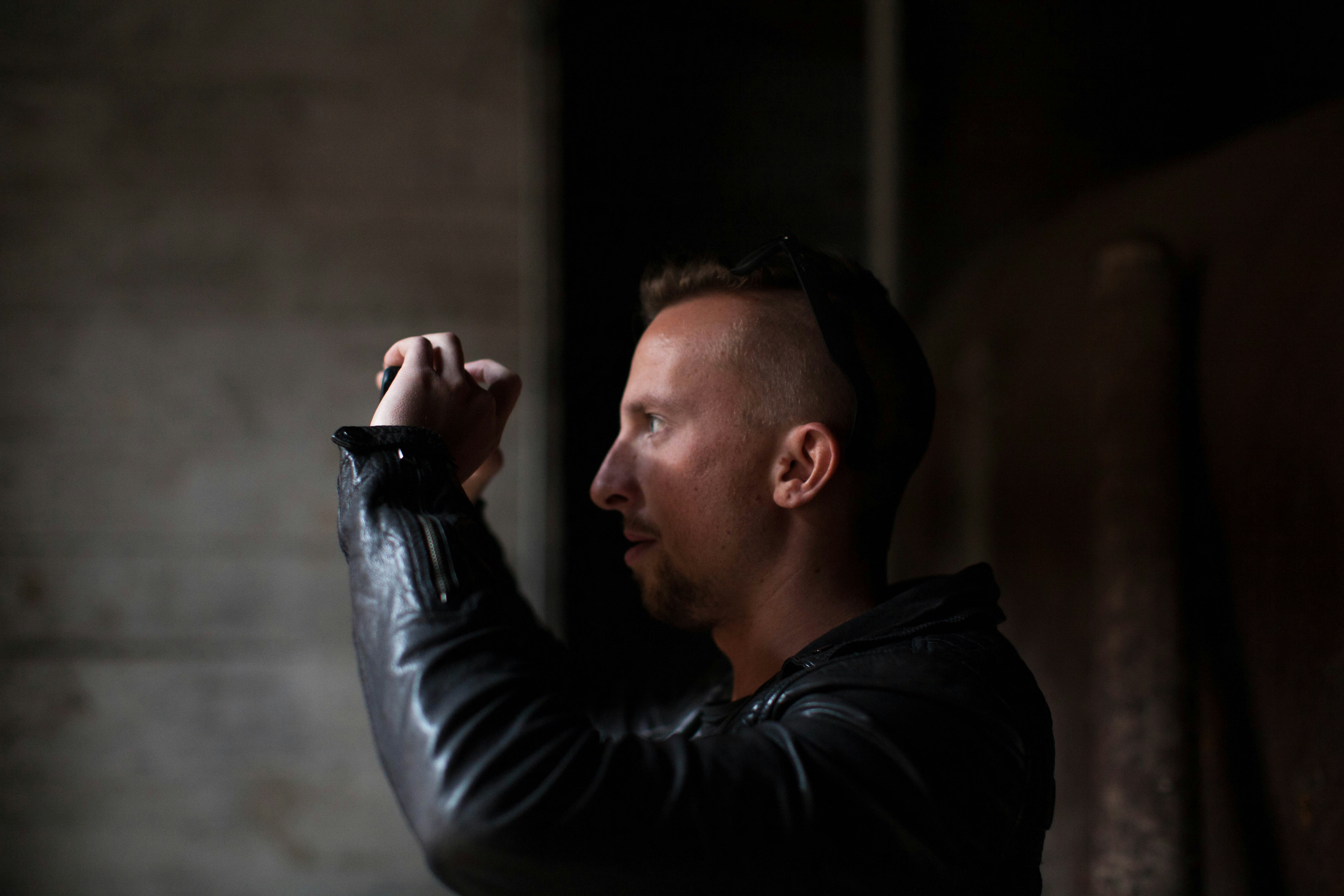 man wearing black leather jacket